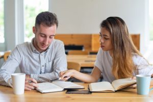two-students-studying-doing-homework-together_1262-16989